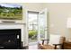 This living room features a fireplace, a tv, and a door leading to the outdoor space at 1940 Dunfield Dr, Fuquay Varina, NC 27526