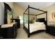 Inviting bedroom with a canopy bed, dresser with a mirror, and neutral decor at 1940 Dunfield Dr, Fuquay Varina, NC 27526