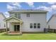 Two story home with sliding glass doors that open to a covered patio and green backyard at 196 Norwich Dr, Clayton, NC 27520
