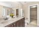 A well-lit bathroom features a double vanity, a walk-in shower, and a separate toilet closet at 196 Norwich Dr, Clayton, NC 27520