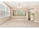 Bright dining room with large windows, neutral walls and carpet, and decorative chandelier at 196 Norwich Dr, Clayton, NC 27520