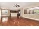 Open-concept living space with hardwood floors connecting to a modern kitchen and entryway at 196 Norwich Dr, Clayton, NC 27520