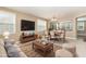 A naturally lit living room includes a comfortable sofa, coffee table, and a dining area view at 196 Norwich Dr, Clayton, NC 27520