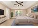 A beige primary bedroom features a tray ceiling, neutral decor, and a large window with natural light at 196 Norwich Dr, Clayton, NC 27520