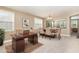 A naturally lit office room includes a desk, dining area view, and two windows for natural light at 196 Norwich Dr, Clayton, NC 27520