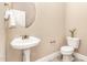 Charming powder room with pedestal sink and decorative accents at 196 Norwich Dr, Clayton, NC 27520