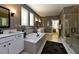 Luxurious bathroom with soaking tub, double vanity, and a separate glass-enclosed shower at 211 George Hudson Rd, Siler City, NC 27344