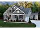 Side view showcasing the home's brick and siding, attached two-car garage, and manicured lawn at 211 George Hudson Rd, Siler City, NC 27344