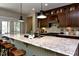 Spacious kitchen with a large center island, granite countertops, and stainless steel appliances at 211 George Hudson Rd, Siler City, NC 27344