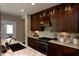 A well-designed kitchen with wood cabinets, stone countertops, and stainless steel appliances at 211 George Hudson Rd, Siler City, NC 27344