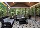 Cozy screened-in porch with comfortable seating, decorative rug, and wooded views at 211 George Hudson Rd, Siler City, NC 27344