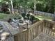 Backyard view of outdoor seating area with built-in fire pit, playground, and fenced-in yard at 215 Rocky Point Ct, Fuquay Varina, NC 27526