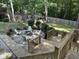 Backyard view of outdoor seating area with built-in fire pit, playground, and fenced-in yard at 215 Rocky Point Ct, Fuquay Varina, NC 27526