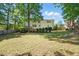 Spacious backyard of home with large grassy area, trees, and fence at 215 Rocky Point Ct, Fuquay Varina, NC 27526