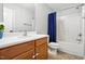 Bathroom with single sink vanity and tub shower combo with blue curtain at 215 Rocky Point Ct, Fuquay Varina, NC 27526