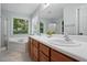 Bathroom boasts a double sink vanity, soaking tub, large window, and a separate shower at 215 Rocky Point Ct, Fuquay Varina, NC 27526