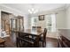 Bright dining room with hardwood floors, chandelier, and large windows with natural light at 215 Rocky Point Ct, Fuquay Varina, NC 27526