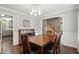 Elegant dining room with hardwood floors and an adjacent staircase at 215 Rocky Point Ct, Fuquay Varina, NC 27526