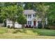 Charming two-story home with a well-manicured lawn and inviting red door at 215 Rocky Point Ct, Fuquay Varina, NC 27526