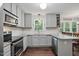 Updated kitchen features grey cabinets, stainless appliances, granite counters, and hardwood floors at 215 Rocky Point Ct, Fuquay Varina, NC 27526