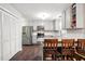 Updated kitchen features grey cabinets, stainless appliances, granite counters, and hardwood floors at 215 Rocky Point Ct, Fuquay Varina, NC 27526