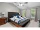 Spacious main bedroom features a vaulted ceiling, neutral paint, two windows, and hardwood floors at 215 Rocky Point Ct, Fuquay Varina, NC 27526