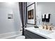 This bathroom features white subway tile, contrasting dark blue vanity and artwork, and a shower with curtain at 217 George Hudson Rd, Siler City, NC 27344