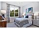 Bedroom with a large window overlooking mature trees and decorative headboard at 217 George Hudson Rd, Siler City, NC 27344