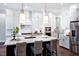 Bright kitchen featuring a center island, stainless steel appliances, and a cozy breakfast bar at 217 George Hudson Rd, Siler City, NC 27344
