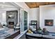 Living room with two fireplaces, sliding glass doors to the outside, and modern furniture at 217 George Hudson Rd, Siler City, NC 27344