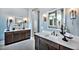 Dual sink vanity in the main bathroom with decorative mirrors and modern fixtures at 217 George Hudson Rd, Siler City, NC 27344