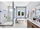 Main bathroom features a freestanding tub, glass shower, and dual sink vanity at 217 George Hudson Rd, Siler City, NC 27344