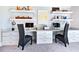 Bright office space features two desks, floating shelves, and lots of drawer space for organized storage at 217 George Hudson Rd, Siler City, NC 27344