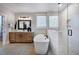 Bright bathroom featuring a soaking tub, a walk-in shower, a modern vanity, and sleek fixtures at 219 George Hudson Rd, Siler City, NC 27344