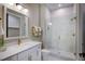 Modern bathroom features white marble tiles, gold fixtures, and a glass-enclosed shower at 219 George Hudson Rd, Siler City, NC 27344