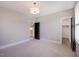 Spacious bedroom with neutral walls, carpet flooring, two open closet doors, and overhead lighting at 219 George Hudson Rd, Siler City, NC 27344