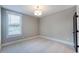 Well-lit bedroom with neutral walls, carpet flooring, one window with views, and overhead lighting at 219 George Hudson Rd, Siler City, NC 27344