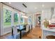 Open dining room features large windows with wooded views and modern decor at 219 George Hudson Rd, Siler City, NC 27344