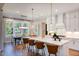 Open concept kitchen boasts stainless appliances, an island with seating, and modern pendant lighting at 219 George Hudson Rd, Siler City, NC 27344