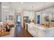 Bright kitchen boasts stainless appliances, gold hardware, and a large island with a farmhouse sink at 219 George Hudson Rd, Siler City, NC 27344