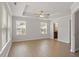 Bright bedroom features a tray ceiling, fan, and a view of the en-suite bathroom at 2211 Sweet Annie Way, Wake Forest, NC 27587