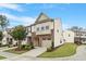 Attractive townhome exterior features a brick front, attached garage, and manicured lawn on a sunny day at 2211 Sweet Annie Way, Wake Forest, NC 27587