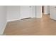 Hardwood-style flooring is shown in this hallway view with closet doors at 2211 Sweet Annie Way, Wake Forest, NC 27587