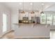 Bright kitchen featuring granite countertops, stainless appliances, pendant lighting, and an adjacent dining area at 2211 Sweet Annie Way, Wake Forest, NC 27587
