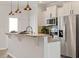 Charming kitchen features stainless steel appliances and a granite breakfast bar with pendant lighting at 2211 Sweet Annie Way, Wake Forest, NC 27587