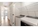 Convenient laundry room featuring a washer, dryer, and shelving for ample storage at 2211 Sweet Annie Way, Wake Forest, NC 27587