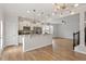Open concept living space with adjacent kitchen, wood floors, and ample natural light at 2211 Sweet Annie Way, Wake Forest, NC 27587