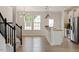Living room flows to the kitchen with an island bar for extra seating and updated appliances at 2211 Sweet Annie Way, Wake Forest, NC 27587