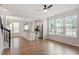 Open concept living space with wood floors, bright windows, and a view of the kitchen and dining areas at 2211 Sweet Annie Way, Wake Forest, NC 27587