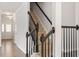 Staircase with wood steps and modern black railings provides access to the upper level at 2211 Sweet Annie Way, Wake Forest, NC 27587